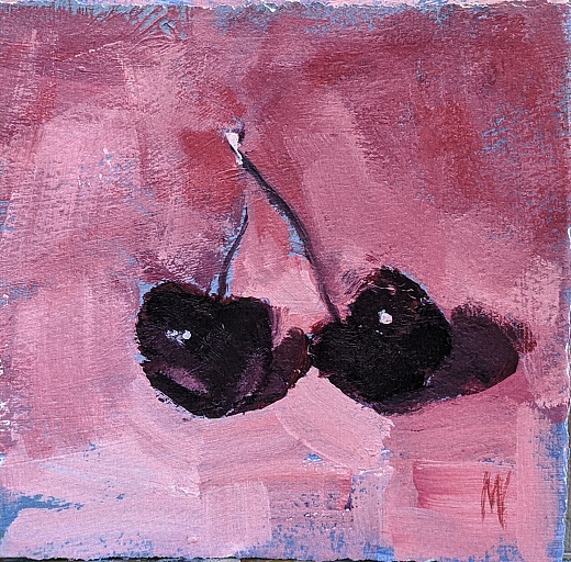 two cherries on pink background
