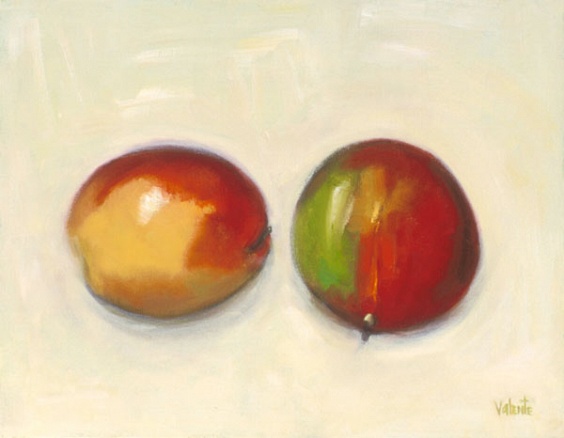 two mangos on cream background