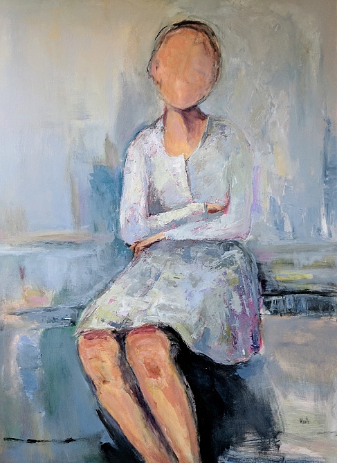 woman in white seated arms crossed