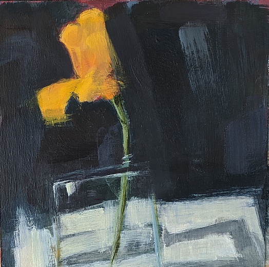 bright yellow poppy in glass vase dark background